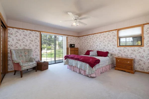 a spacious bedroom with a bed and a couch