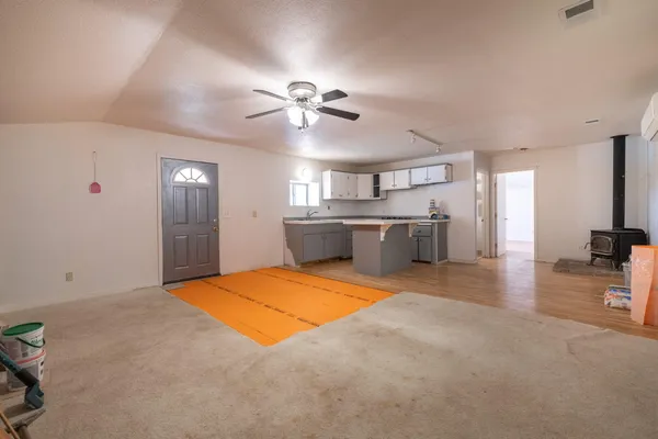 a kitchen with stainless steel appliances kitchen island granite countertop a sink cabinets and wooden floor