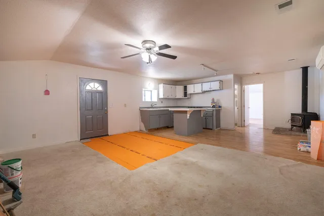 a kitchen with stainless steel appliances kitchen island granite countertop a sink cabinets and wooden floor