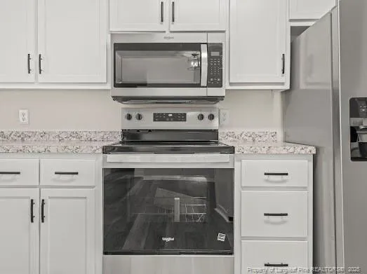 a kitchen with appliances cabinets and a stove top oven
