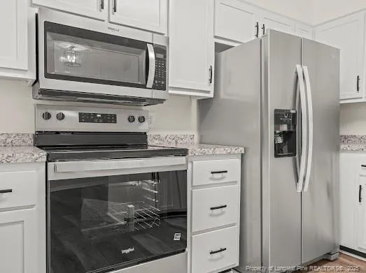a stove top oven sitting inside of a kitchen