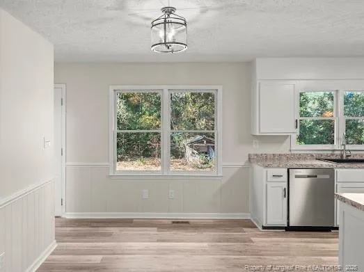 a view of a kitchen with granite countertop cabinets stainless steel appliances and a large window