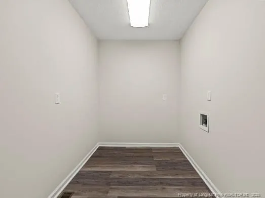 a view of a small space with wooden floor and a window