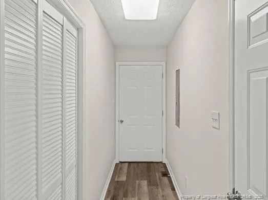 a view of a room with wooden floor and a window