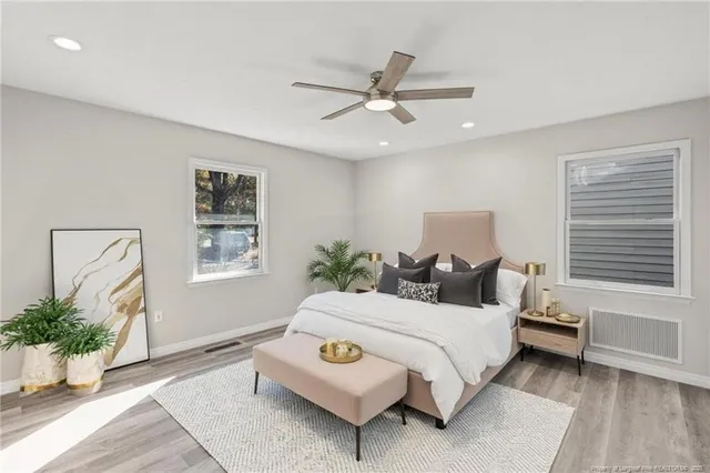 a bedroom with a bed lamp and window