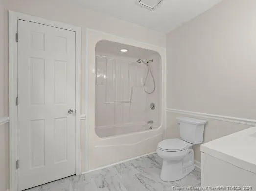 a bathroom with a toilet and shower