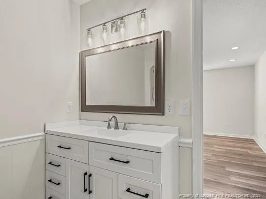 a bathroom with a sink vanity and a mirror