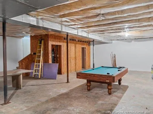 a backyard of a house with barbeque oven table and chairs