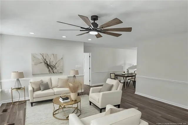 a living room with furniture and a ceiling fan