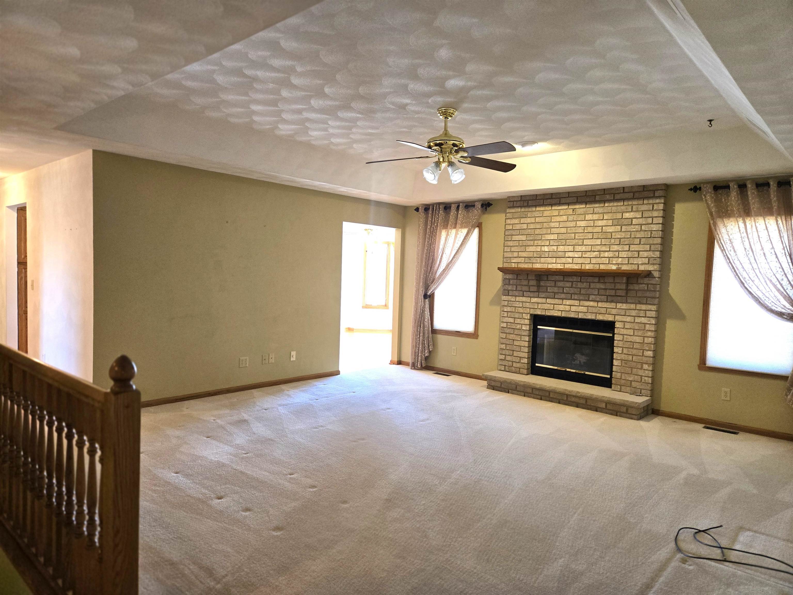 2862 Dourdan Road Belvidere, IL 61008 - Photo 7 of 28 a view of an empty room with a fireplace and a window