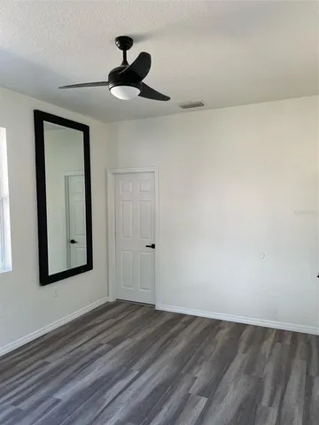a view of an empty room and wooden floor