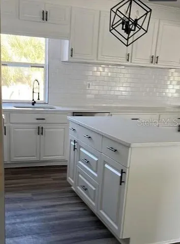 a kitchen with stainless steel appliances granite countertop a sink a stove and cabinets
