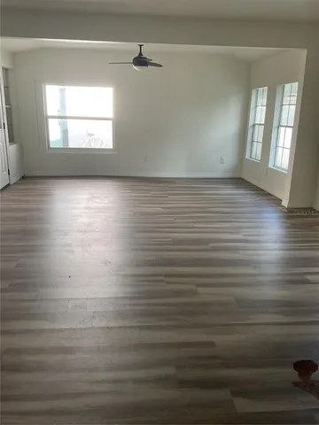 wooden floor in a room next to a window