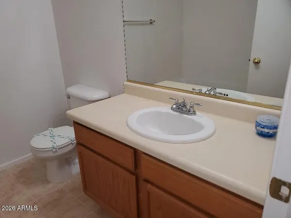 a bathroom with a sink a toilet and a mirror