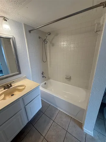 a spacious bathroom with a tub a sink and a shower