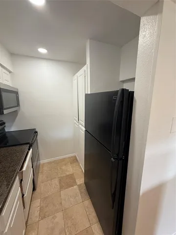 a kitchen with a refrigerator and a sink