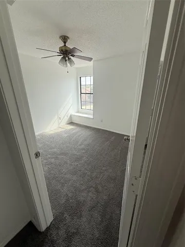 a view of empty room with a fireplace