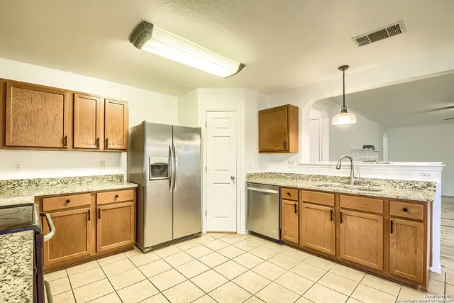 a kitchen with a sink stove and cabinets