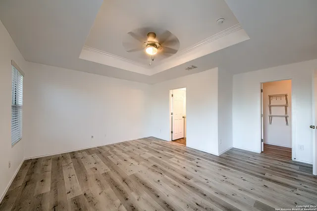 a view of empty room with wooden floor
