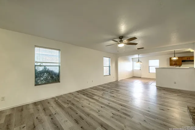 wooden floor in an empty room with a window