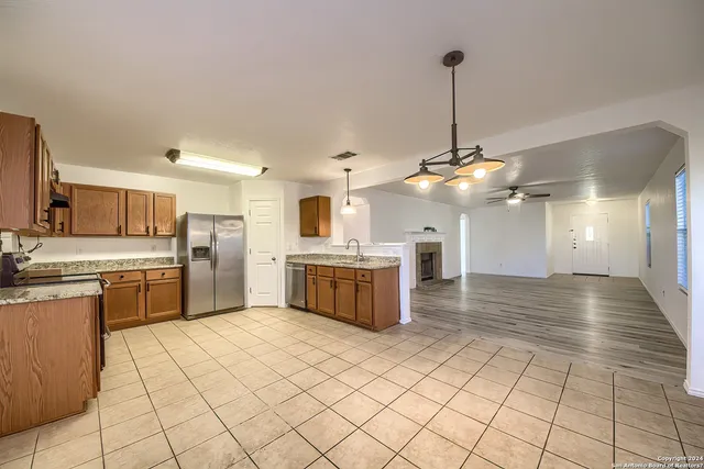 a kitchen with stainless steel appliances kitchen island granite countertop a sink cabinets and counter top space