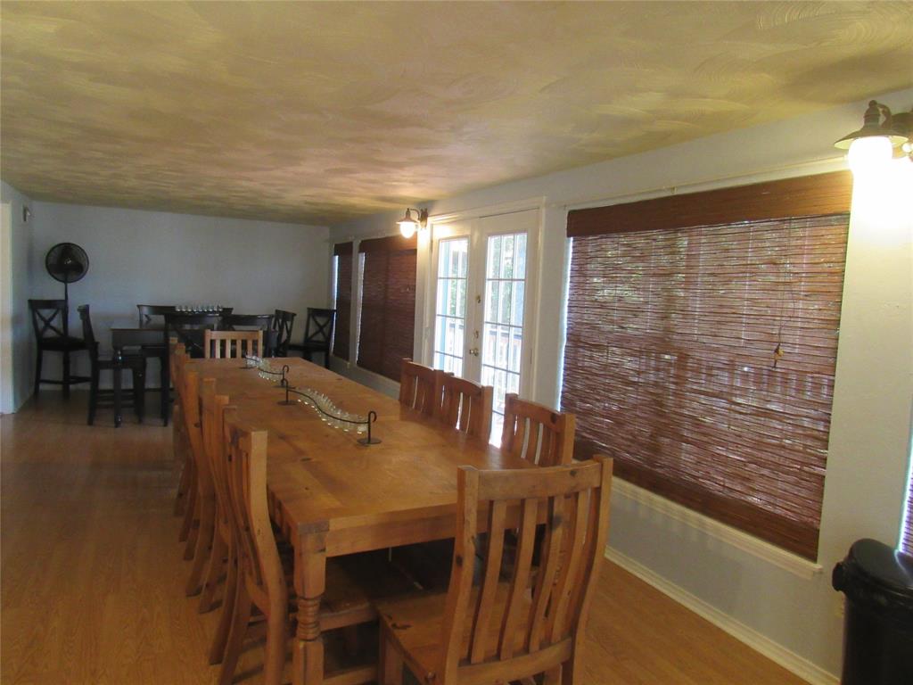 498 Homesite Road Pottsboro, TX 75076 - Photo 12 of 35 a dining room with furniture and wooden floor