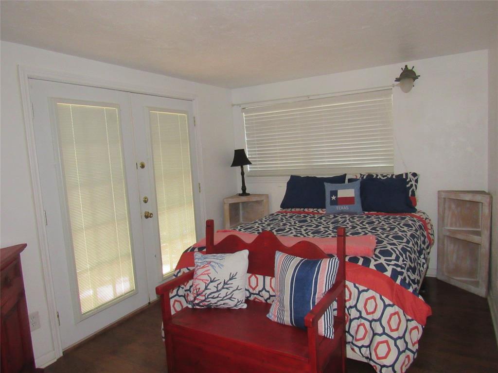 498 Homesite Road Pottsboro, TX 75076 - Photo 20 of 35 a bedroom with a bed and wooden floor