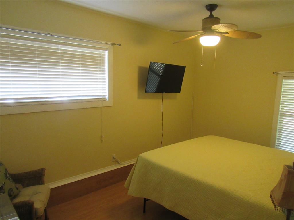 498 Homesite Road Pottsboro, TX 75076 - Photo 25 of 35 a bedroom with a bed and a chandelier