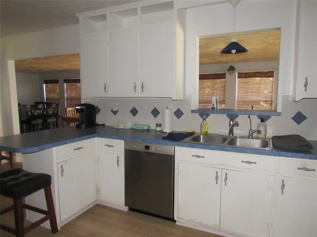 498 Homesite Road Pottsboro, TX 75076 - Photo 30 of 35 a kitchen with granite countertop white cabinets and white appliances