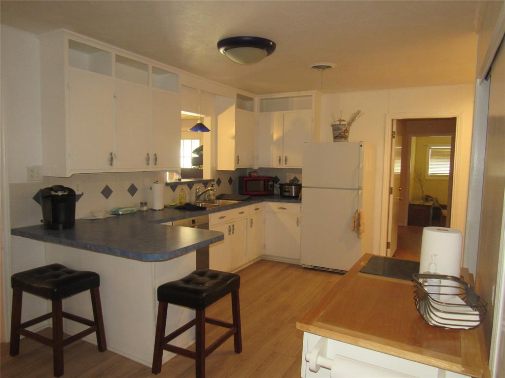 498 Homesite Road Pottsboro, TX 75076 - Photo 10 of 35 a kitchen with a sink and chairs