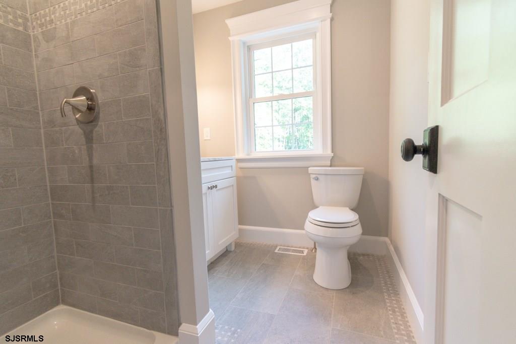 419 Chestnut Neck Road Port Republic, NJ 08241 - Photo 12 of 25 a bathroom with a toilet and a shower