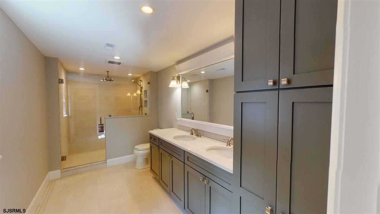 419 Chestnut Neck Road Port Republic, NJ 08241 - Photo 16 of 25 a bathroom with a sink a toilet and shower