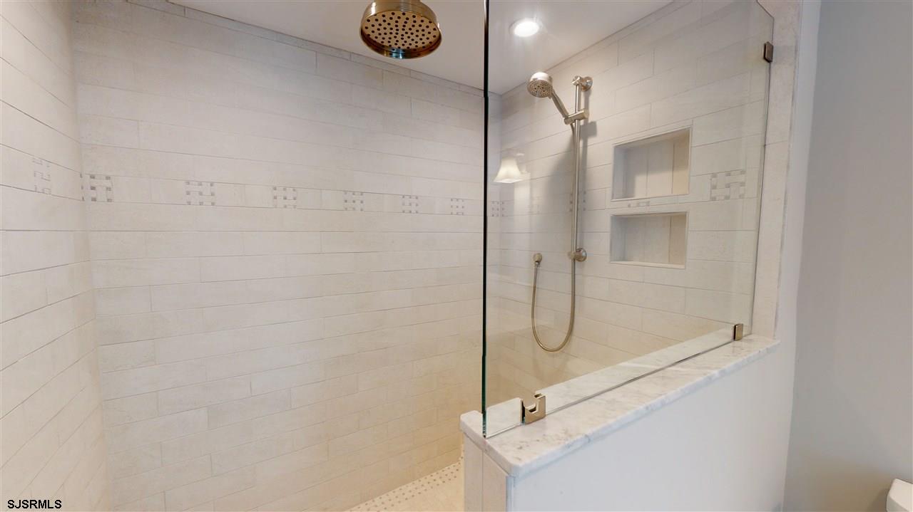 419 Chestnut Neck Road Port Republic, NJ 08241 - Photo 17 of 25 a bathroom with a glass shower door
