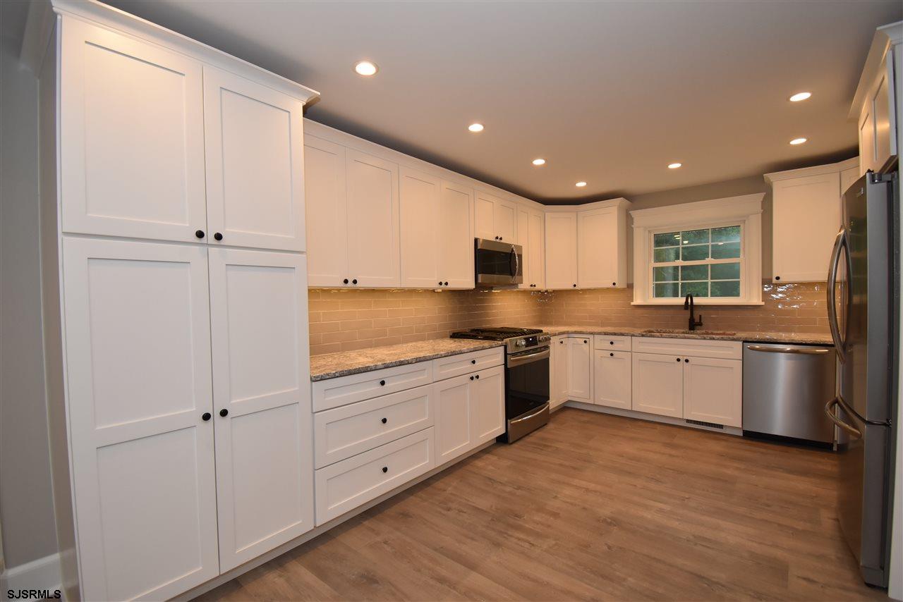 419 Chestnut Neck Road Port Republic, NJ 08241 - Photo 2 of 25 a large kitchen with stainless steel appliances granite countertop a stove a sink and a refrigerator