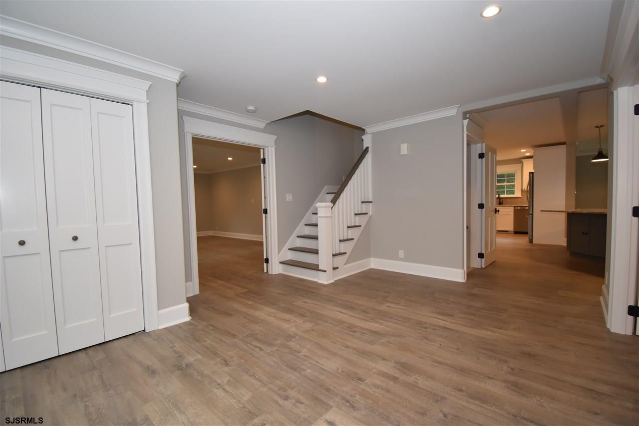 419 Chestnut Neck Road Port Republic, NJ 08241 - Photo 4 of 25 an empty room with wooden floor and windows