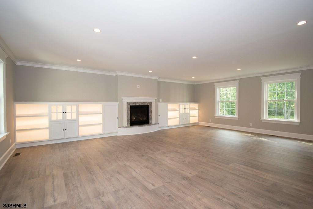 419 Chestnut Neck Road Port Republic, NJ 08241 - Photo 8 of 25 a view of an empty room with a window and wooden floor