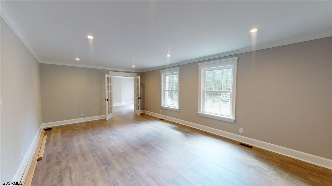 419 Chestnut Neck Road Port Republic, NJ 08241 - Photo 9 of 25 an empty room with wooden floor and windows