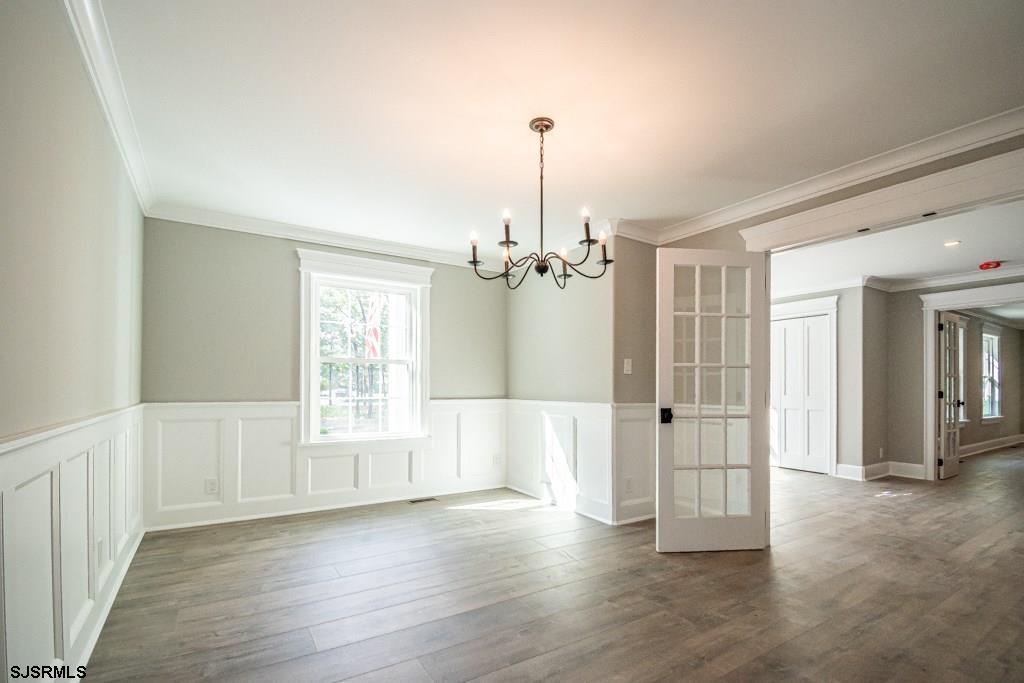 419 Chestnut Neck Road Port Republic, NJ 08241 - Photo 10 of 25 a view of an empty room with wooden floor and a window