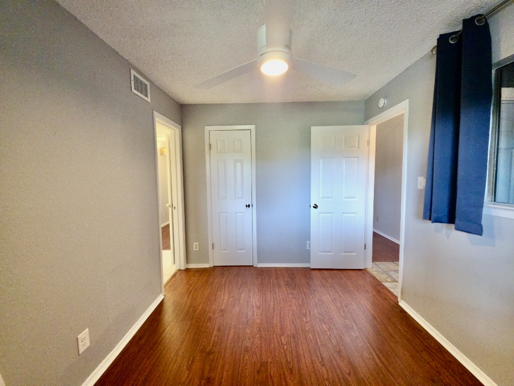 2500 Burleson Road, Unit 521 Austin, TX 78741 - Photo 17 of 20 Interior space featuring wood-finish flooring and light gray walls