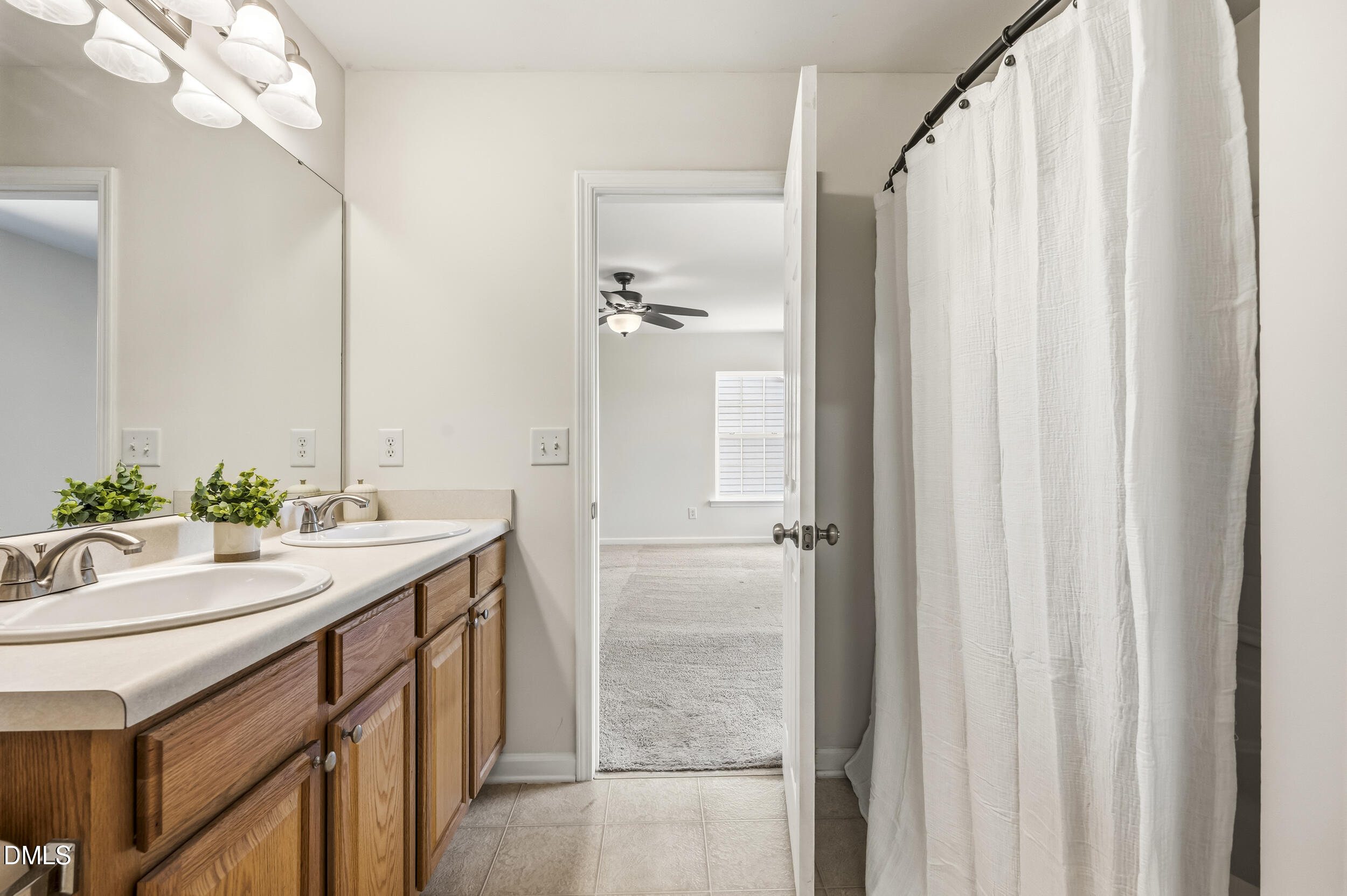 112 Ryder Cup Circle Raleigh, NC 27603 - Photo 25 of 45 a bathroom with a double vanity sink and a mirror
