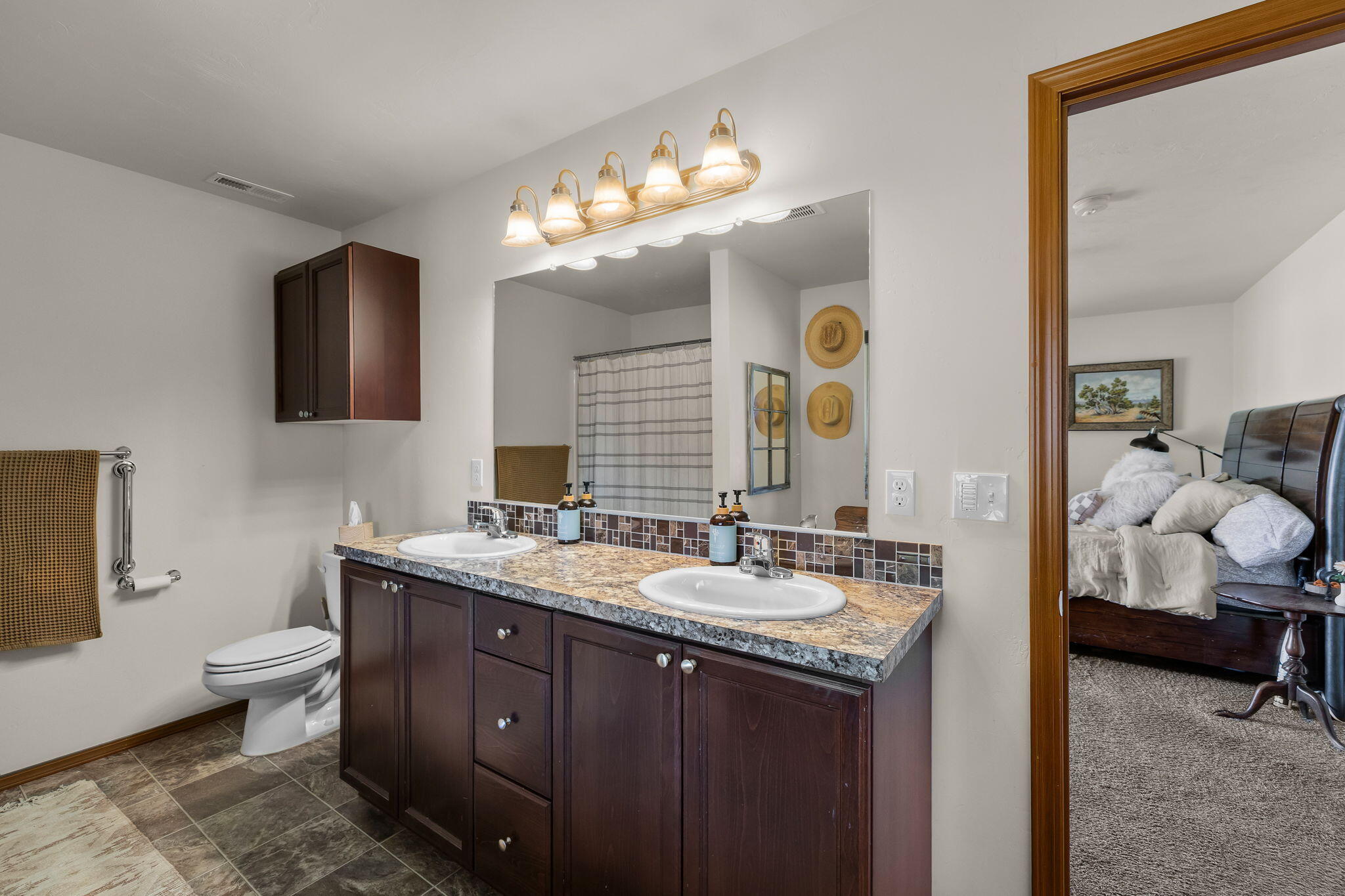 63639 Gentry Loop Bend, OR 97701 - Photo 20 of 40 a spacious bathroom with a granite countertop sink a toilet and a mirror