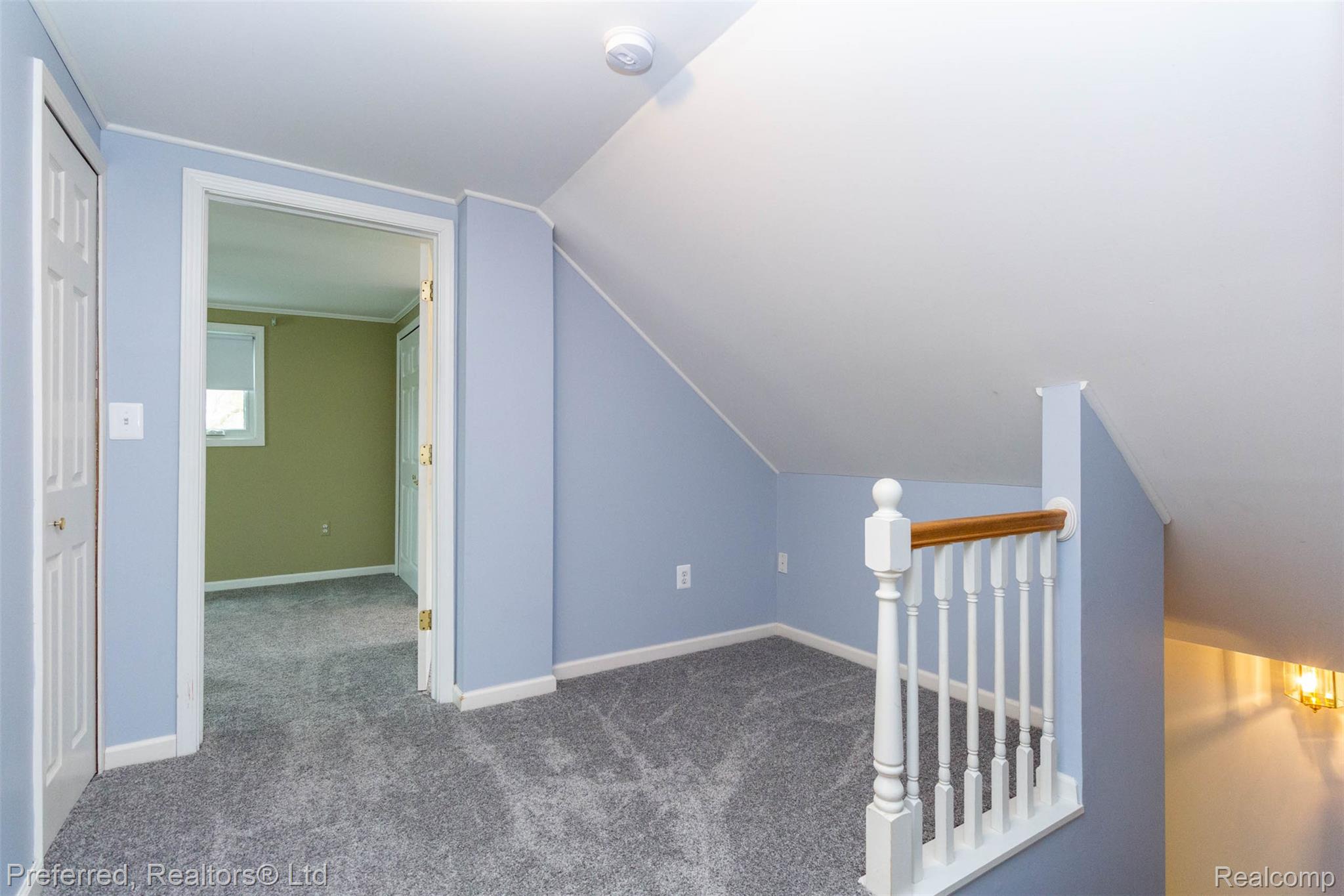 9840 Currie Road Northville, MI 48167 - Photo 20 of 62 Additional living space featuring carpet flooring and lofted ceiling