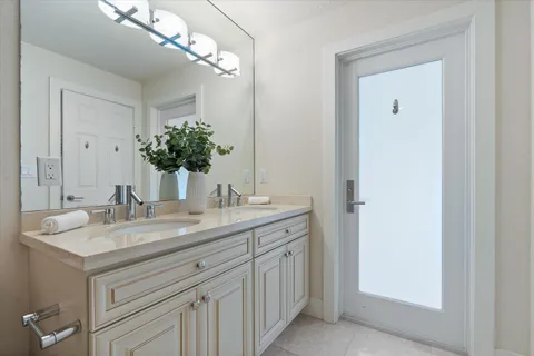 a bathroom with a granite countertop sink a large mirror and a