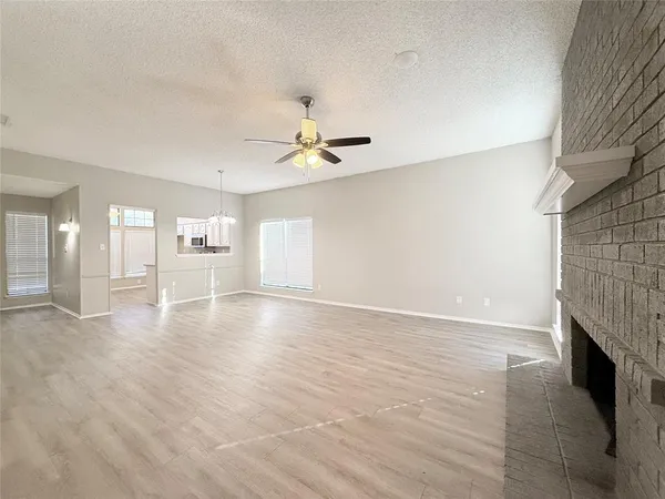 wooden floor in an empty room with a fireplace