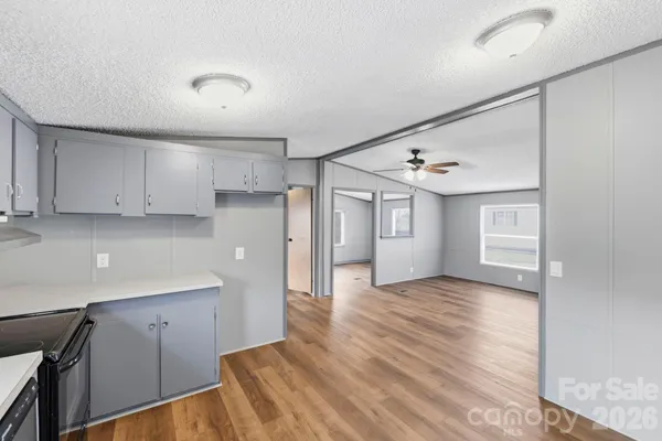 a view of a kitchen with a sink and dishwasher cabinet