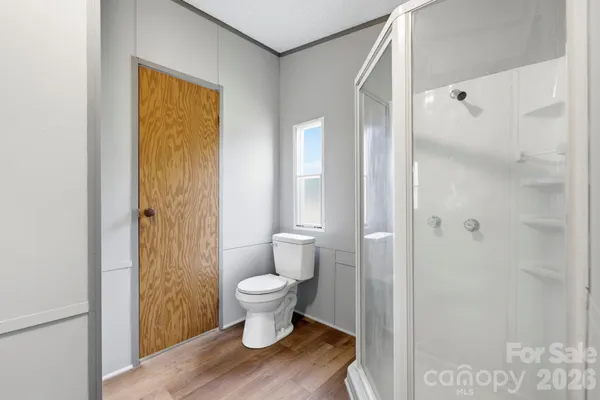 a view of bathroom with toilet a sink and a shower