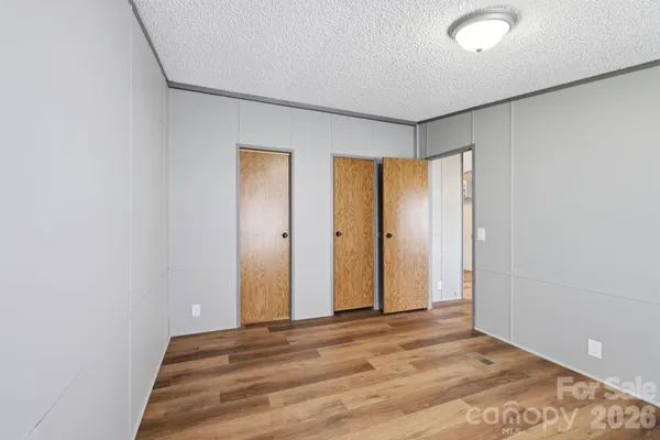 a view of a room with wooden floor