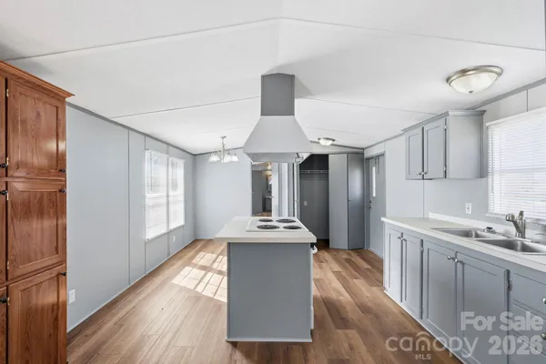 a kitchen with granite countertop a sink stainless steel appliances and cabinets