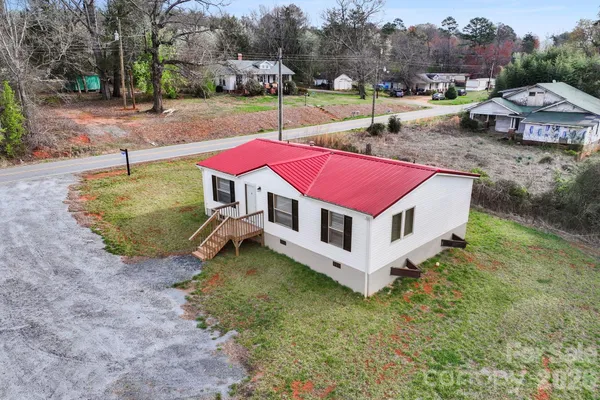 an aerial view of a house with garden space and street view