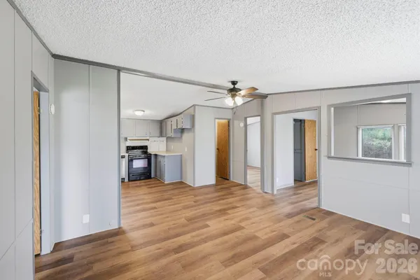 a view of a kitchen with a sink and a refrigerator